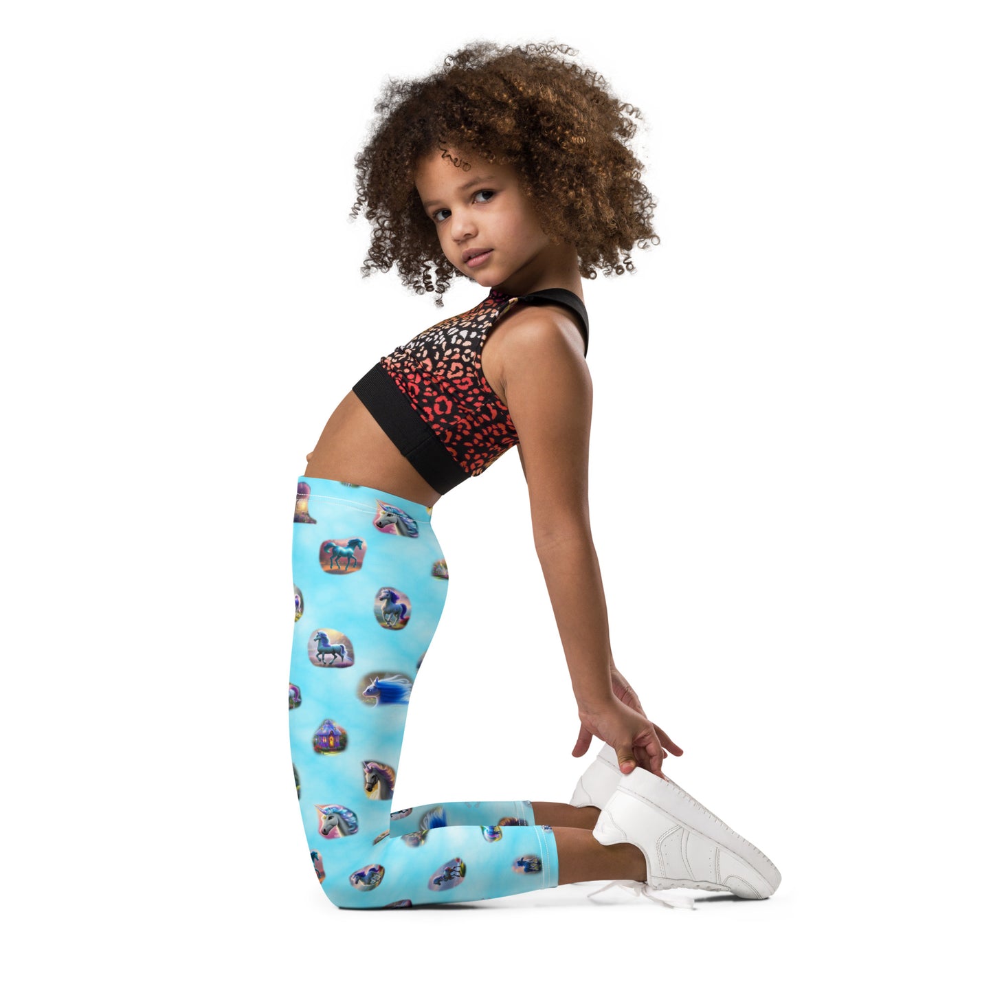 A picture of a girl wearing a "Ponies Unicorns & Fairy Houses" kids leggings - left