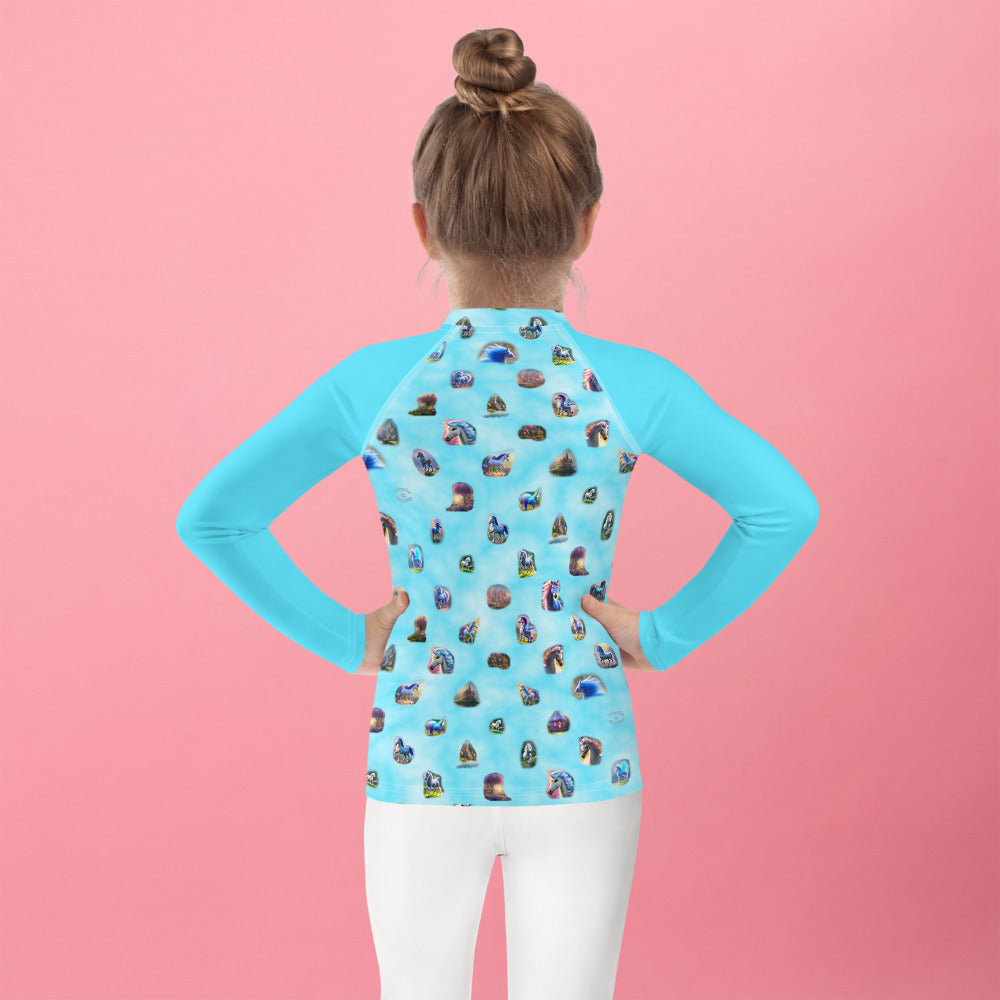 A picture of a girl wearing a "Ponies Unicorns & Fairy Houses" kids Rash Guard - back