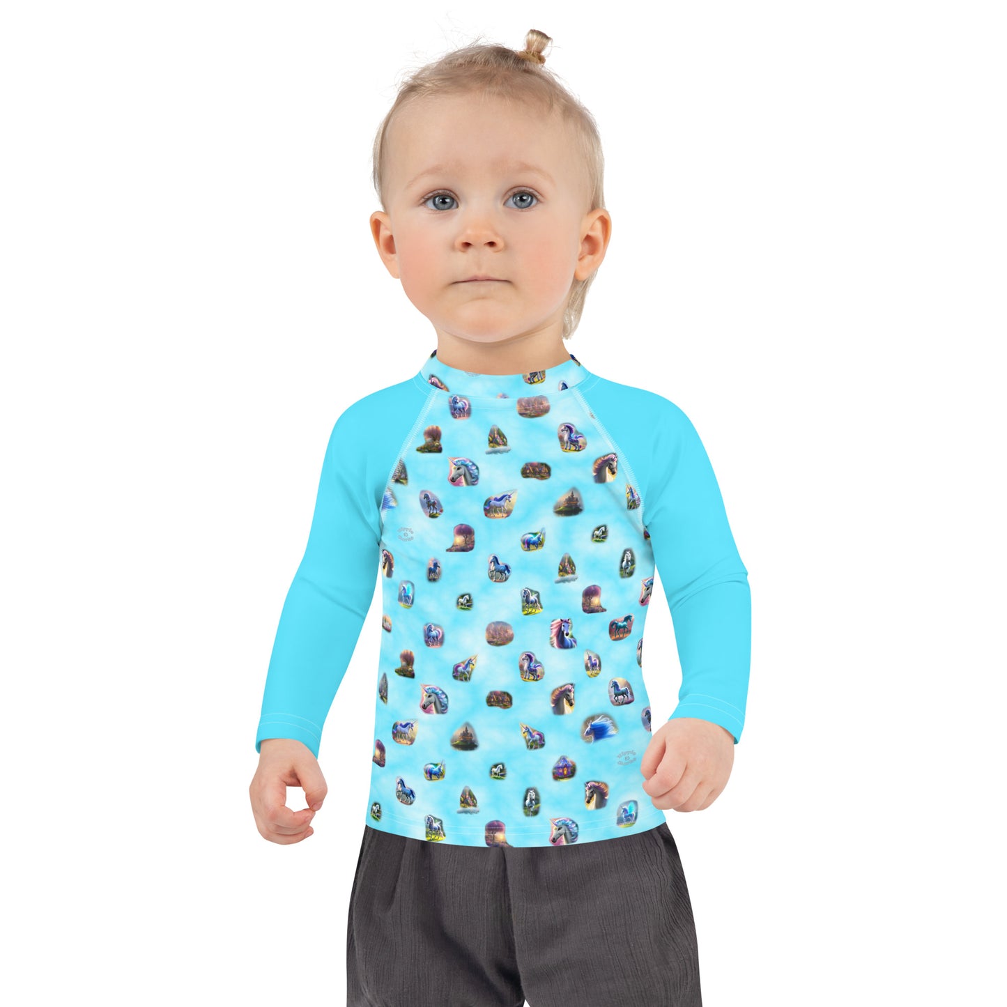A picture of a toddler wearing a "Ponies Unicorns & Fairy Houses" kids Rash Guard - front