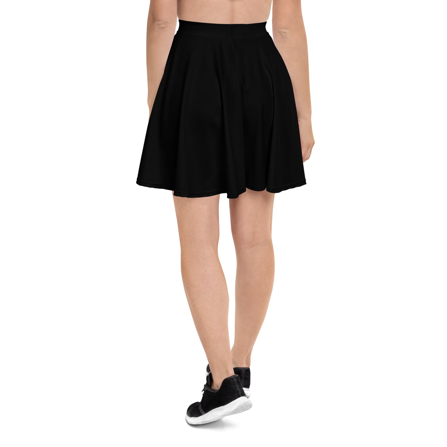 A picture of a woman waist down wearing a Products "Black" Skater Skirt and black shoes - back side