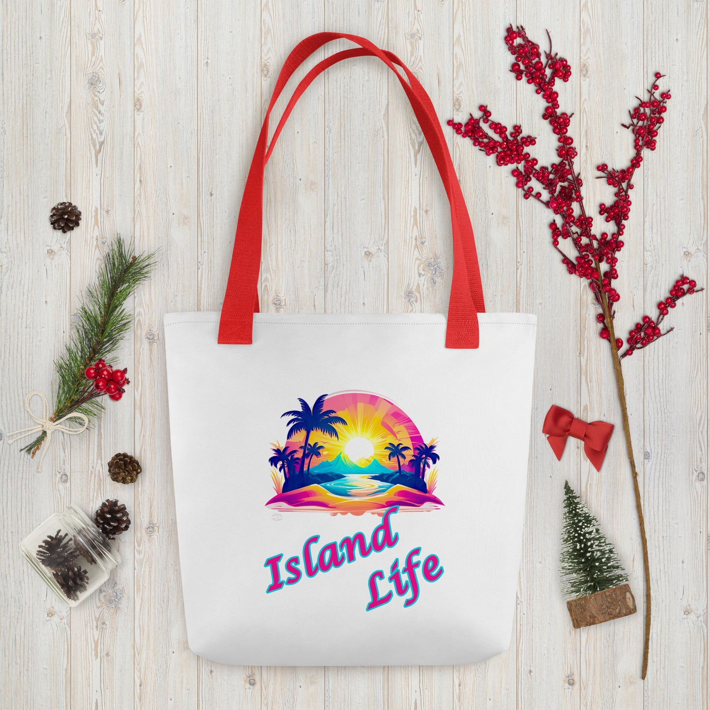 A picture of a Island Life Tote bag with a large picture of a tropical island paradise and the text Island Life underneath - red handles