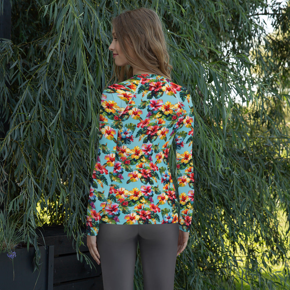 A picture of a woman modeling a Hawaiian Hibiscus Flower patterned Women's Rash Guard - back
