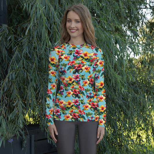 A picture of a woman modeling a Hawaiian Hibiscus Flower patterned Women's Rash Guard - front