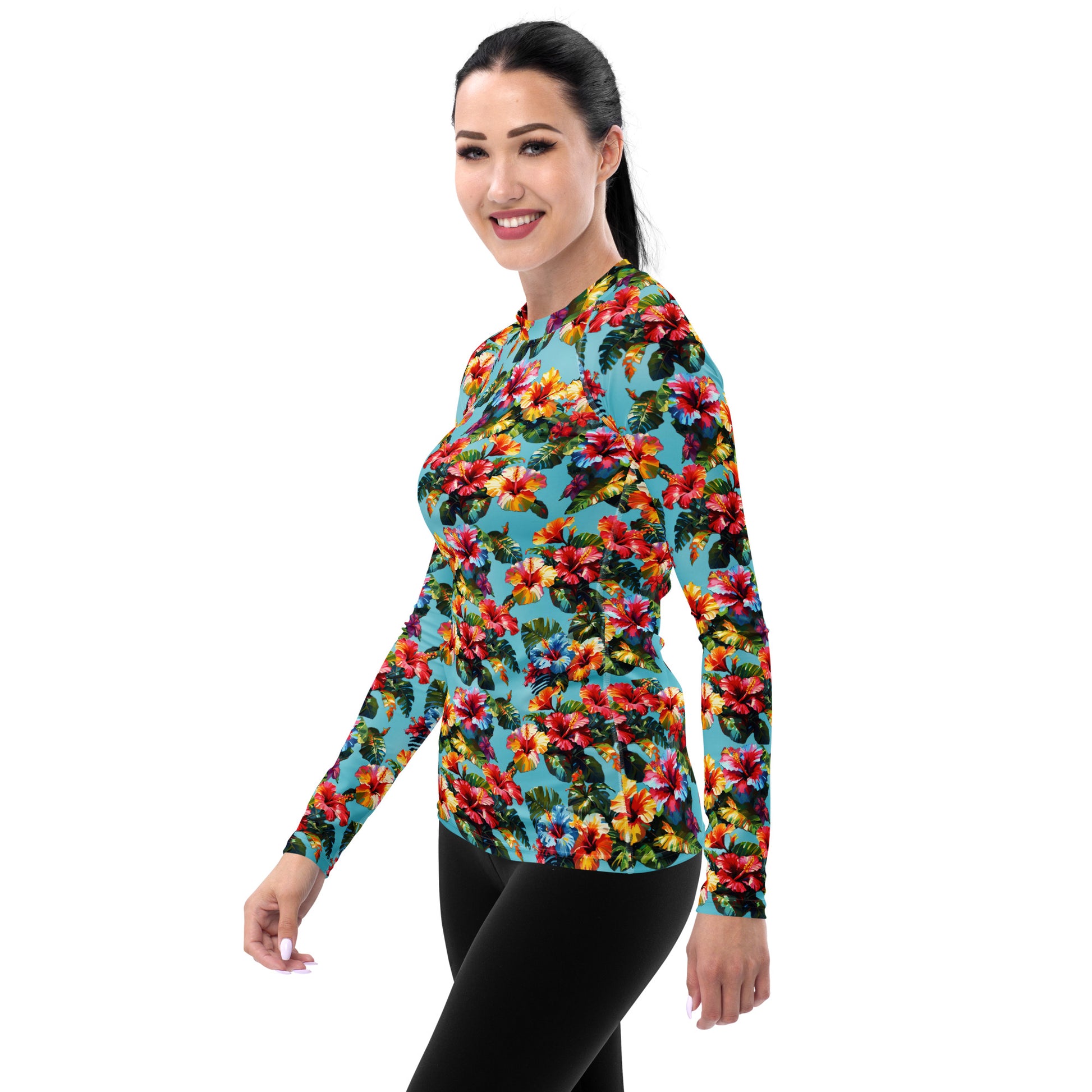 A picture of a woman modeling a Hawaiian Hibiscus Flower patterned Women's Rash Guard - left front