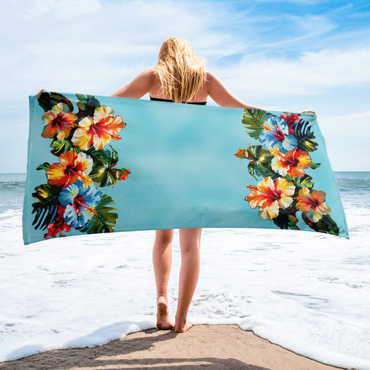 A picture of a woman holding a Hawaiian Hibiscus Flower patterned Beach Towel - 30 x 60 inch - front