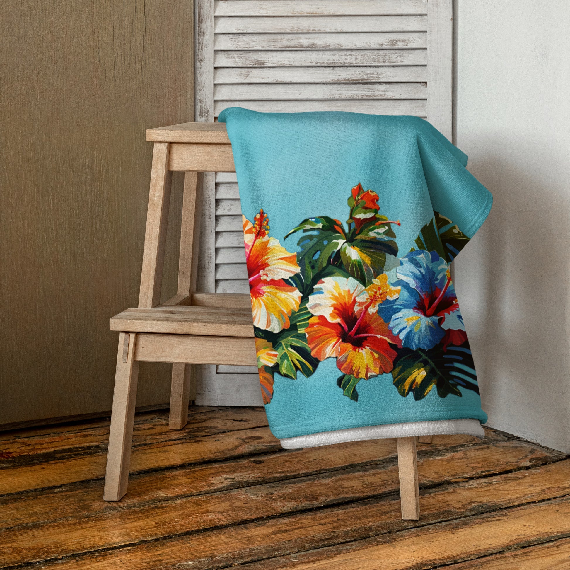 A picture of a Hawaiian Hibiscus Flower patterned Beach Towel folded over a chair - 30 x 60 inch - front