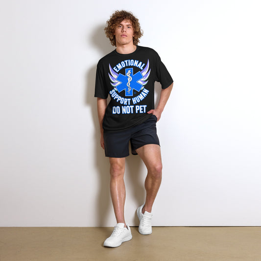 A man wearing a tshirt with a big blue cross and a Rod of Asclepius inside. Text around the cross says Emotional Support Human DO NOT PET - black  