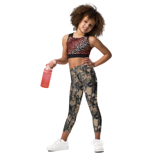 A picture of a little girl wearing Camouflage all over print  kids leggings - left front side 