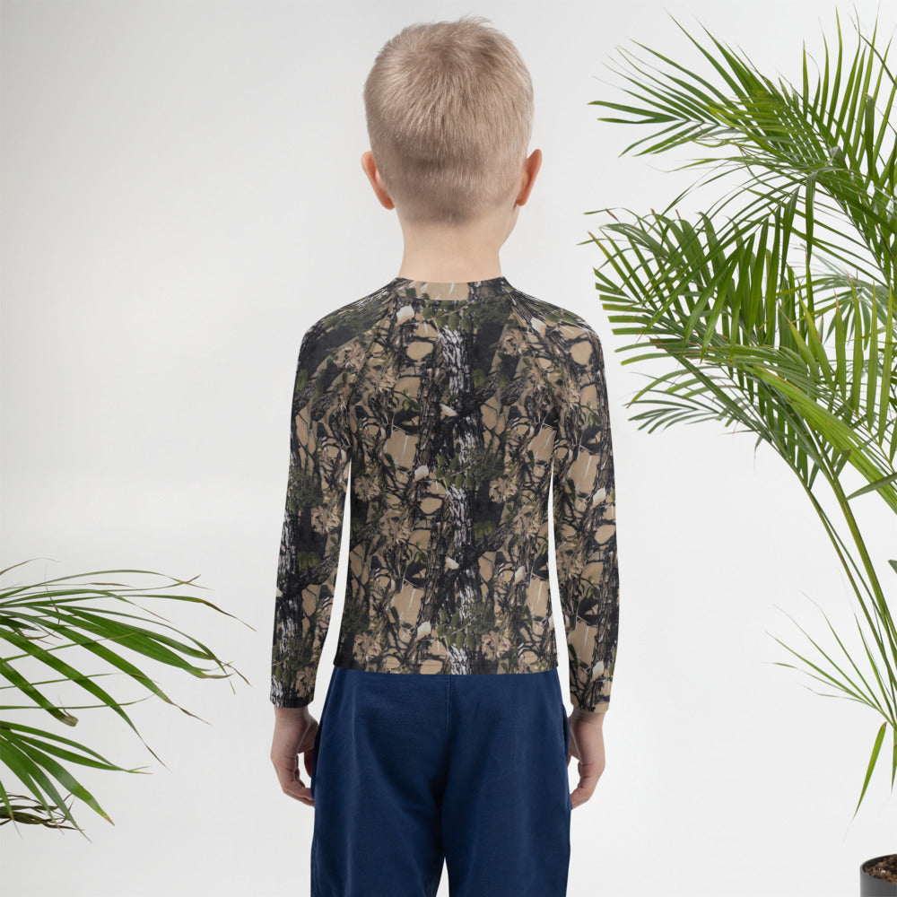 A picture of a little boy wearing a Camouflage all over print kids rash guard - back side