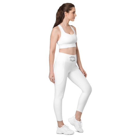 A picture of a woman standing in a yoga pose wearing White Leggings with Pockets - right front side