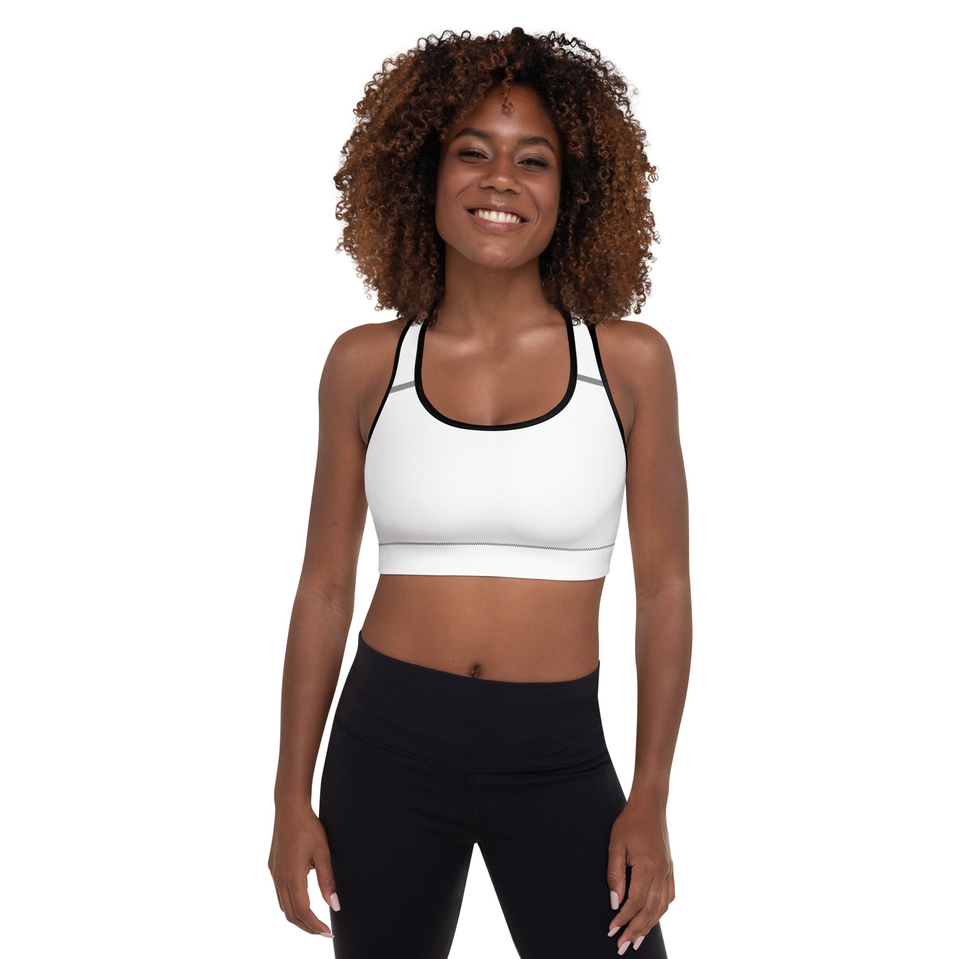 A picture of a woman standing in a wearing a yoga White Padded Sports Bra - front side