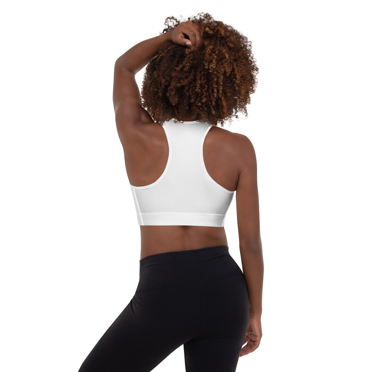 A picture of a woman standing in a wearing a yoga White Padded Sports Bra - back side