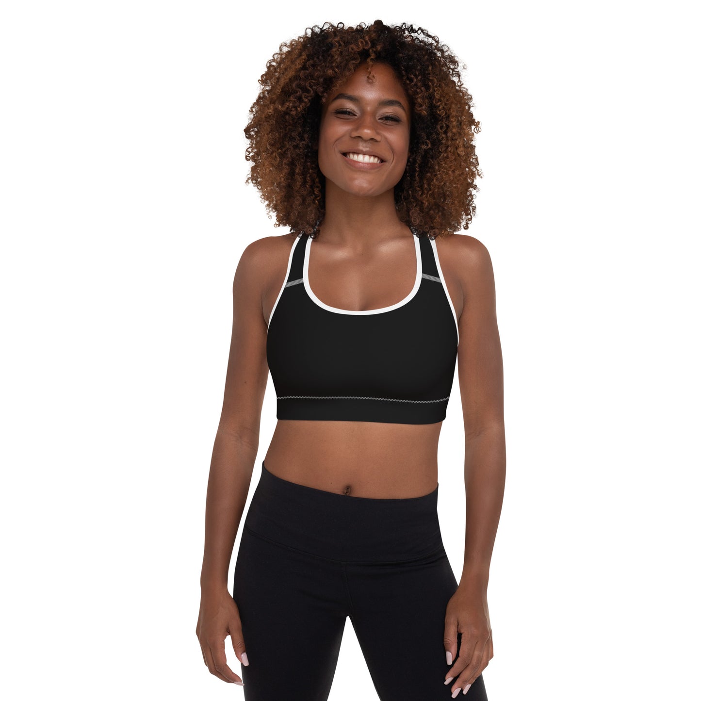 A picture of a women standing facing the camera wearing a Black padded sports bra - crop top - front side