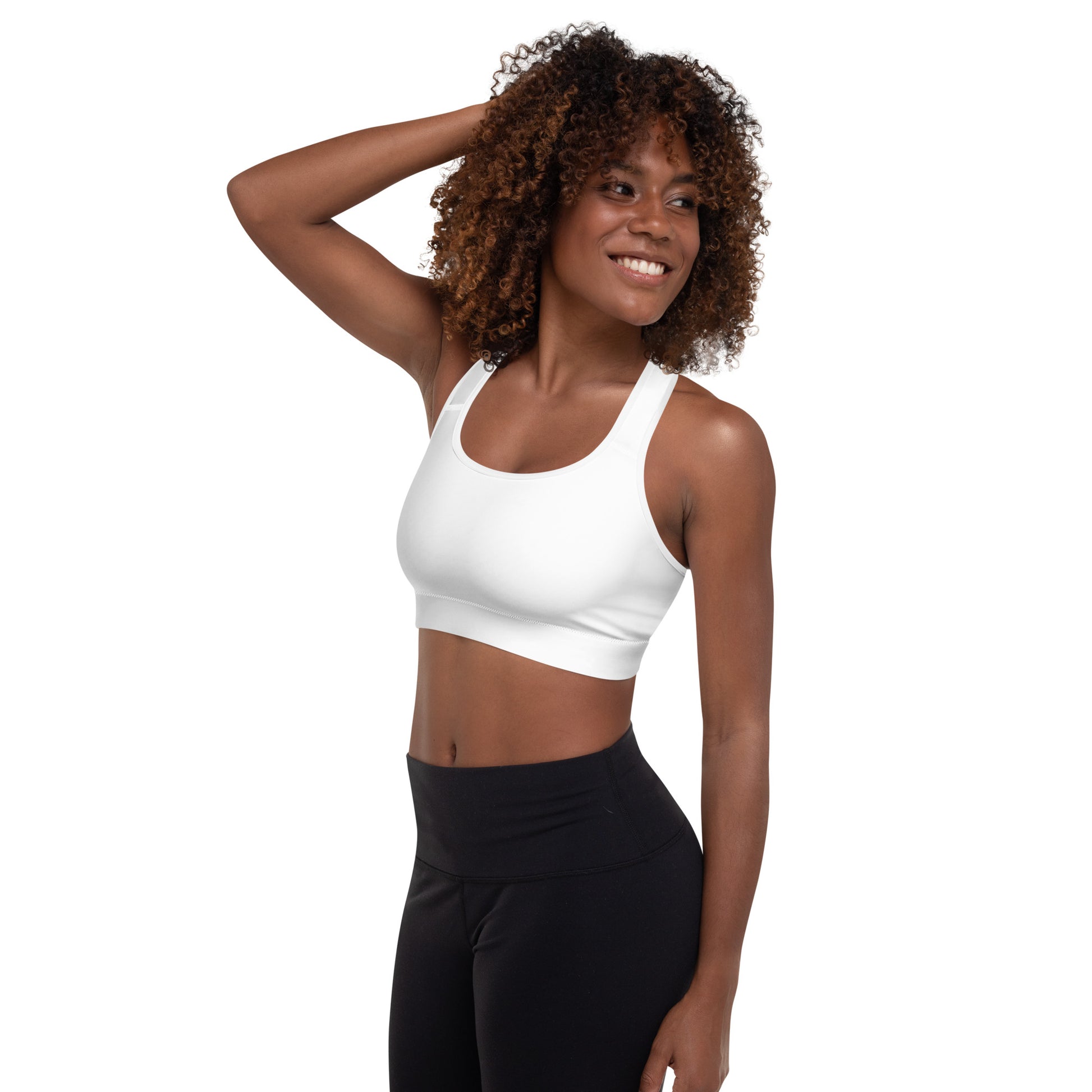 A picture of a woman standing in a wearing a yoga White Padded Sports Bra - left side