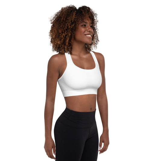 A picture of a woman standing in a wearing a yoga White Padded Sports Bra - right side