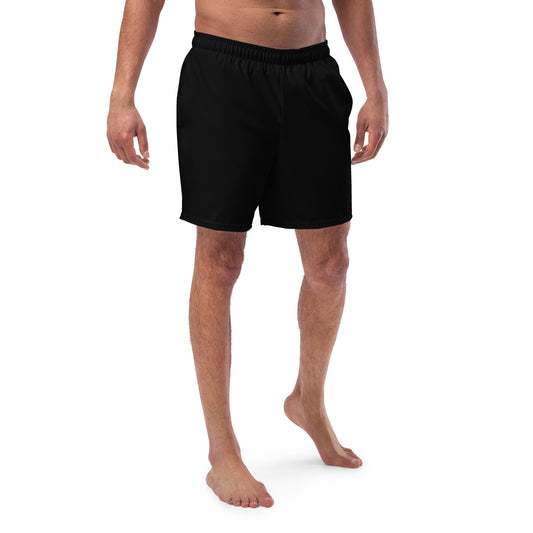 A picture of a man waist down wearing black swim trunks-shorts-front