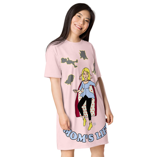 A women wearing a short sleeve tshirt dress which has on the front a cartoon women in a cape juggling her family like a jester and the text Mom's LIFE - right front - light pink