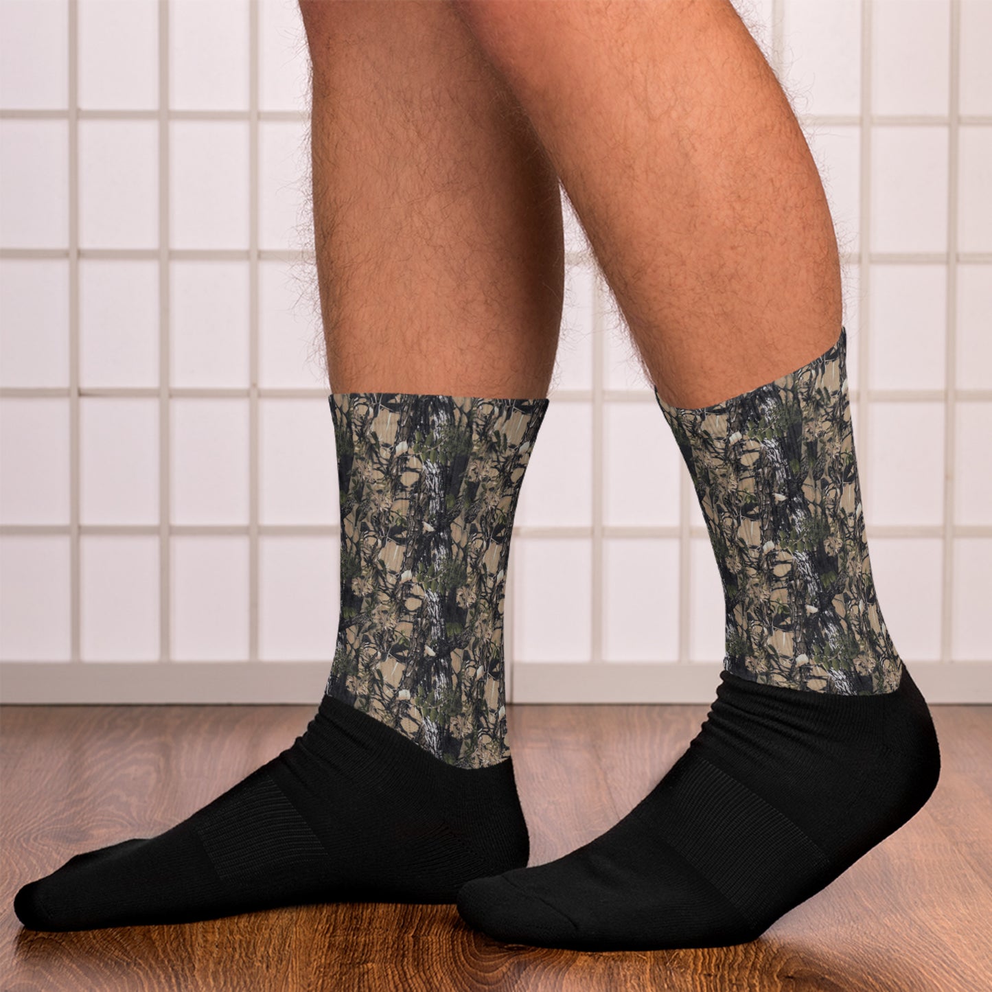 A picture of a pair of legs from the knee down with Camouflage Socks on the feet - left