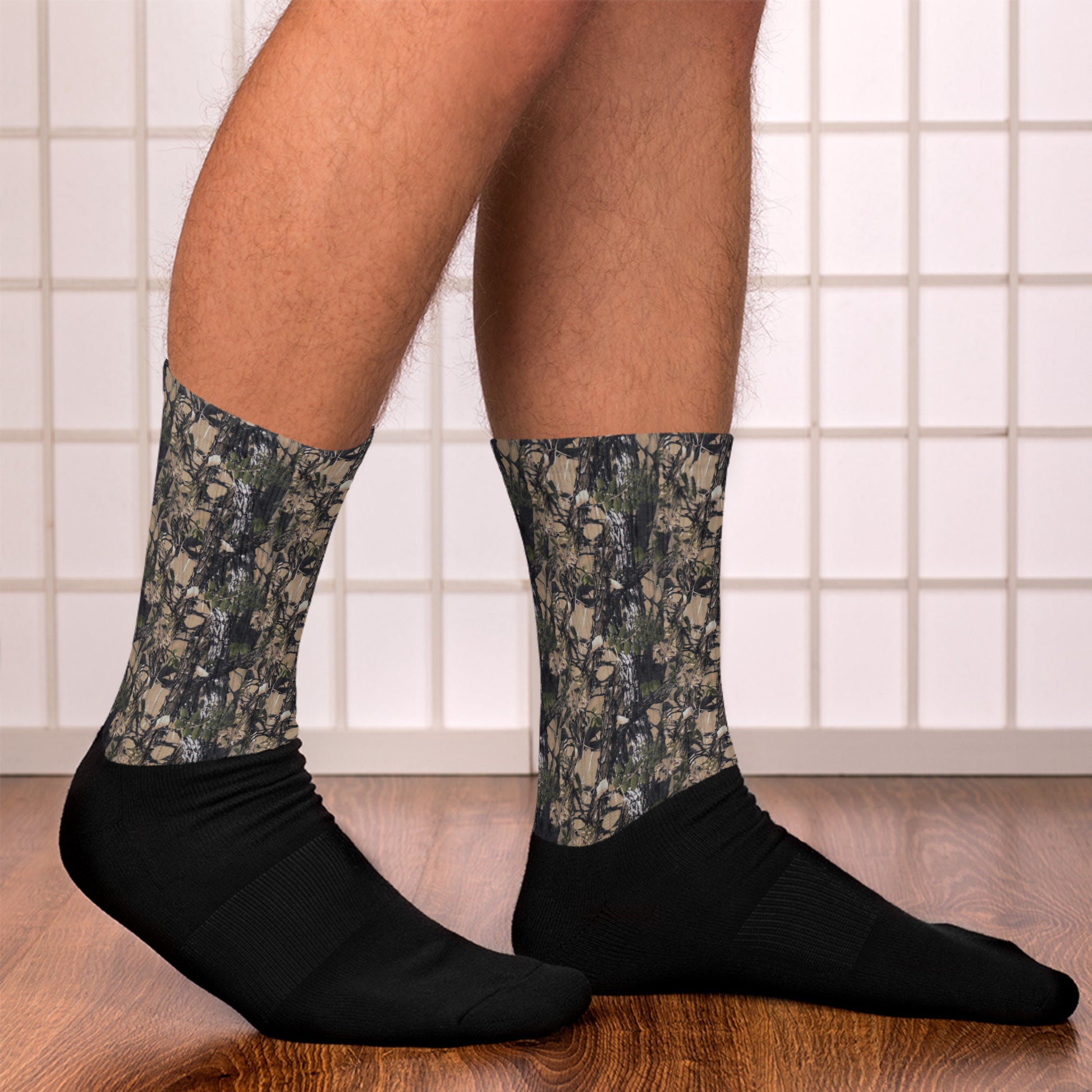 A picture of a pair of legs from the knee down with Camouflage Socks on the feet - right