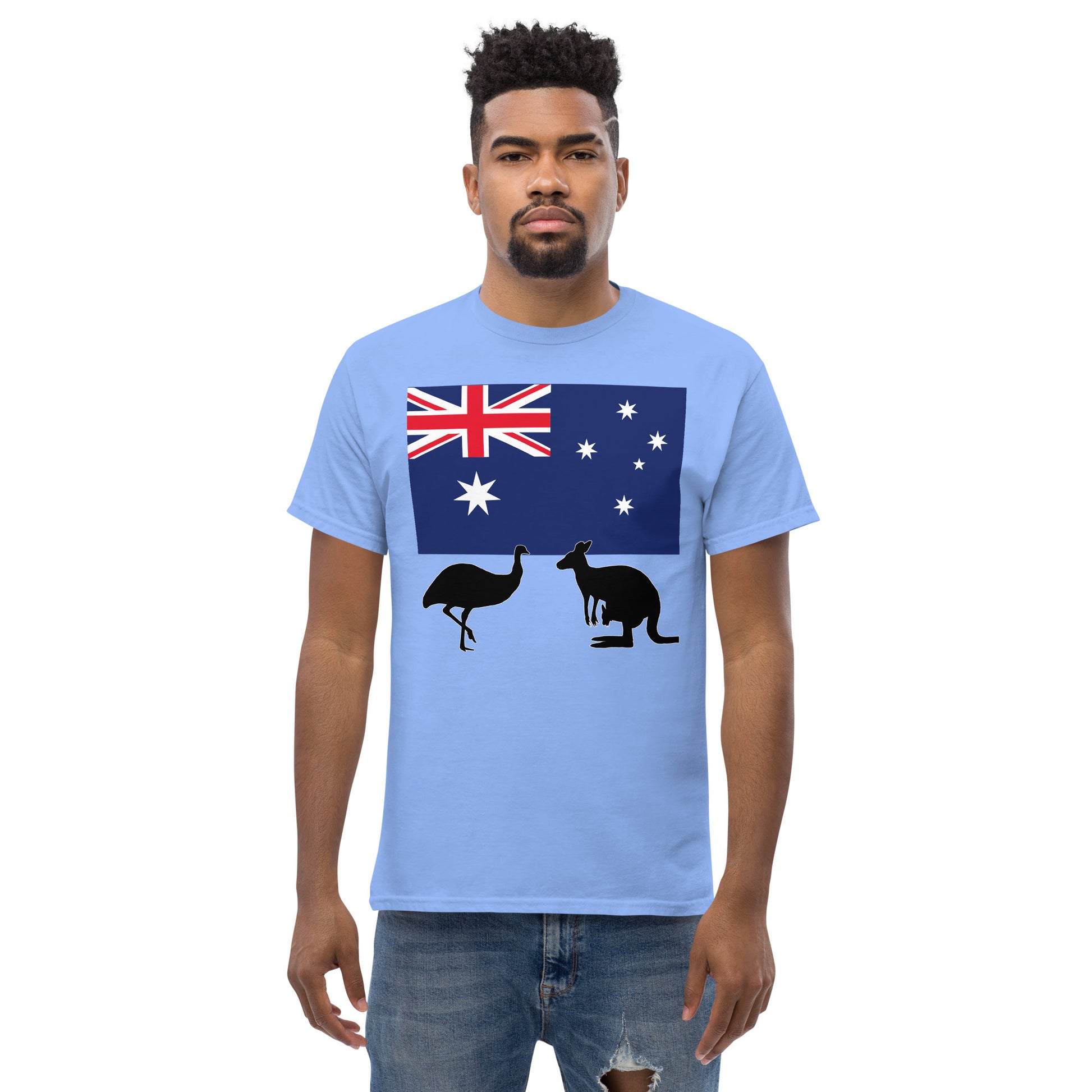 A man wearing a short sleeve tshirt and on the front is Australian flag on the front of a tshirt with the Australian Flag and the silhouettes of an Emu and a kangaroo below - Shirt color caroloina blue