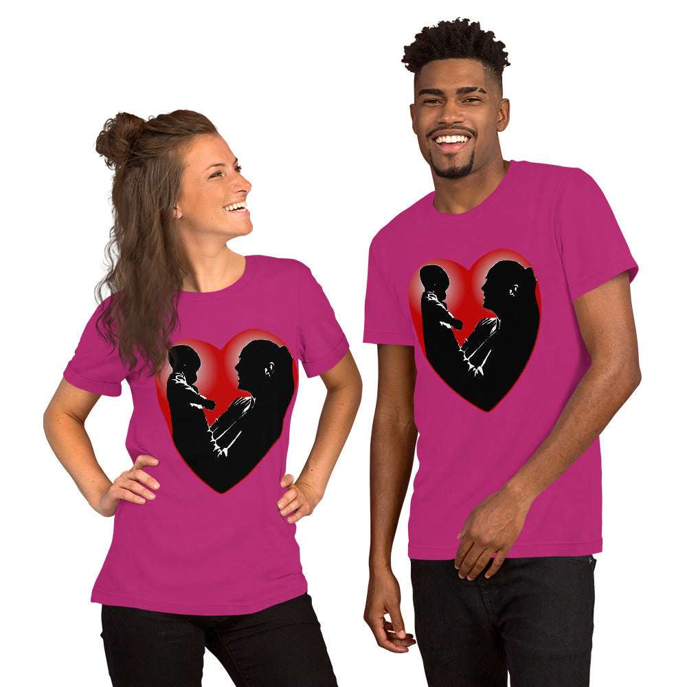 A man and a women wearing matching short sleeve tshirt with a picture on the front of a mother holding up a baby in silhouette with white light shining from behind and a red love heart framing them - Front - berry pink