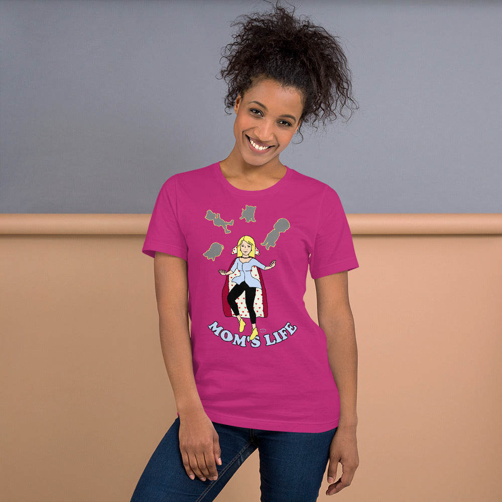 A women wearing a short sleeve unisex tshirt with a pictuer on the front of a mother in a cape juggling her family with the text at the bottom Mom's Life - Front - berry pink