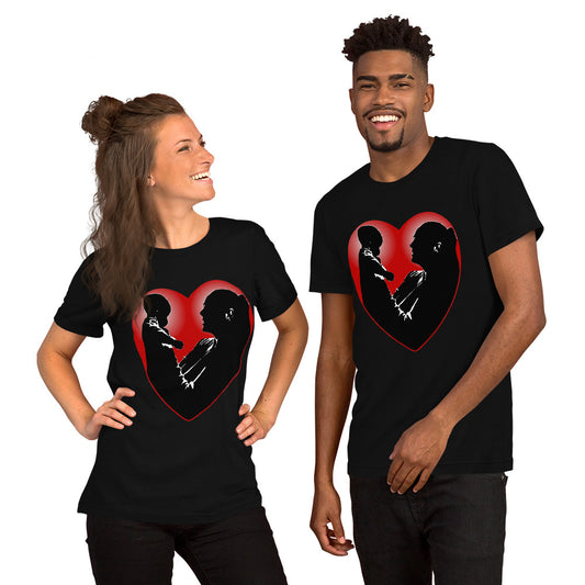 A man and a women wearing matching short sleeve tshirt with a picture on the front of a mother holding up a baby in silhouette with white light shining from behind and a red love heart framing them - Front - black