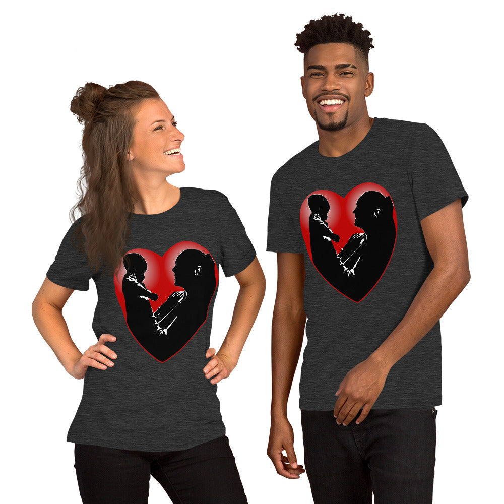 A man and a women wearing matching short sleeve tshirt with a picture on the front of a mother holding up a baby in silhouette with white light shining from behind and a red love heart framing them - Front - dark grey heather