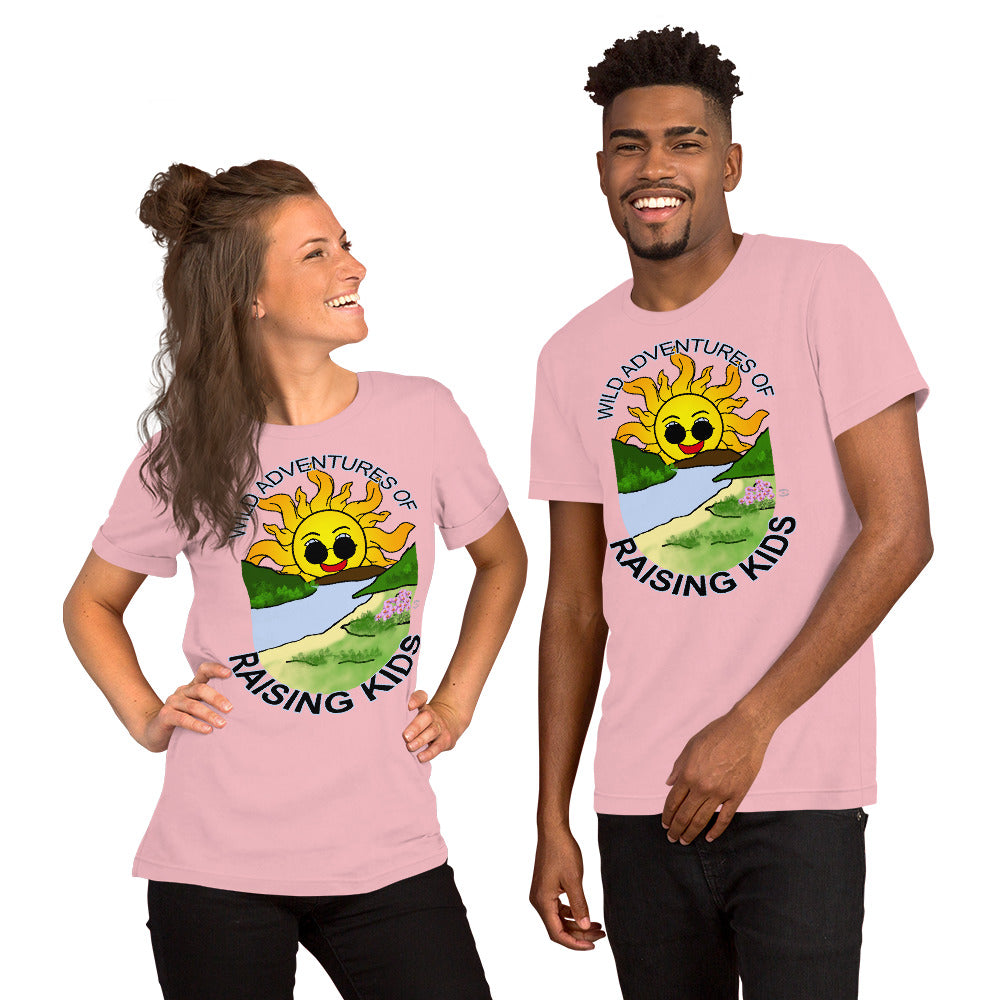 A man and a woman wearing matching tshirts with a picture of the sun coming up over the mountains with sunglasses on and a little stream gently flowing trees and bushes can be seen on the closer mountains and a small beach with some flowers are on the closes bank around the outside of the picture is written "Wild Adventures of Raising Kids" unisex tshirt - pink front