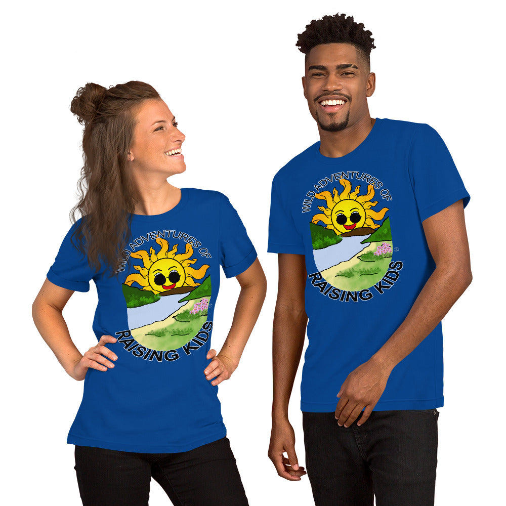 A man and a woman wearing matching tshirts with a picture of the sun coming up over the mountains with sunglasses on and a little stream gently flowing trees and bushes can be seen on the closer mountains and a small beach with some flowers are on the closes bank around the outside of the picture is written "Wild Adventures of Raising Kids" unisex tshirt - royal blue front