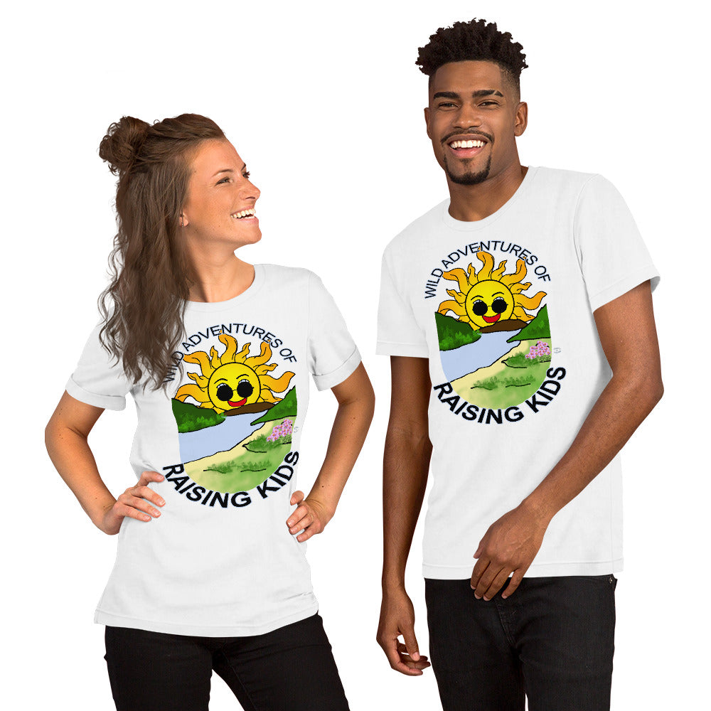 A man and a woman wearing matching tshirts with a picture of the sun coming up over the mountains with sunglasses on and a little stream gently flowing trees and bushes can be seen on the closer mountains and a small beach with some flowers are on the closes bank around the outside of the picture is written "Wild Adventures of Raising Kids" unisex tshirt - white front